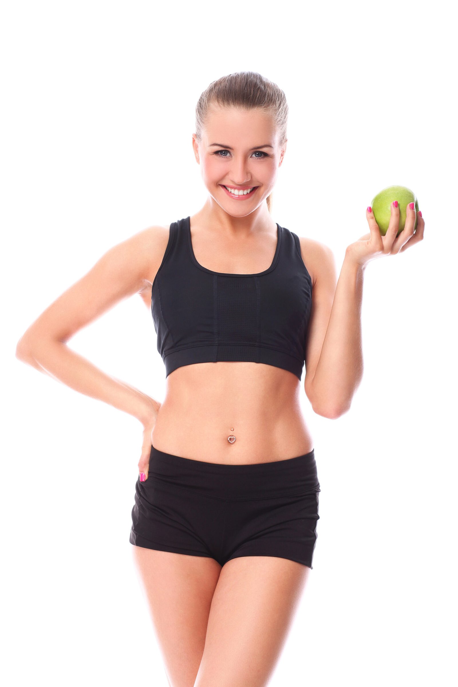 A slim, beautiful girl holds a fresh green apple in her hand, promoting healthy eating and wellness.