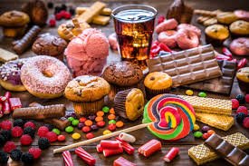 Assortment of sugary products including candies, pastries, and soft drinks.