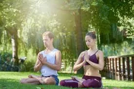 A person meditating, symbolizing stress management.